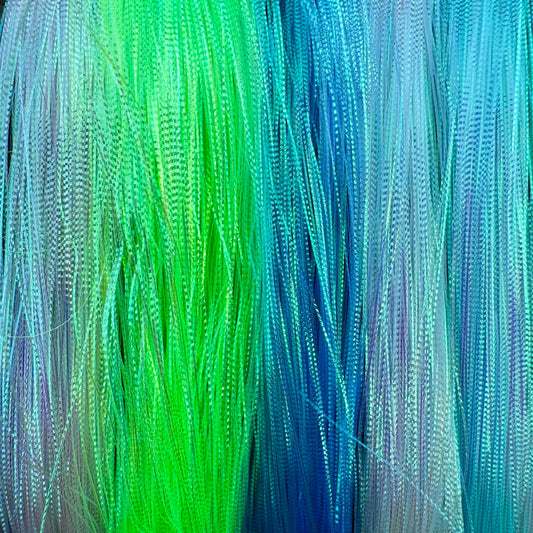Close-up of Upavon Apex Predator Micro Scale Flash fly tying material in silver, used for creating detailed fishing flies.