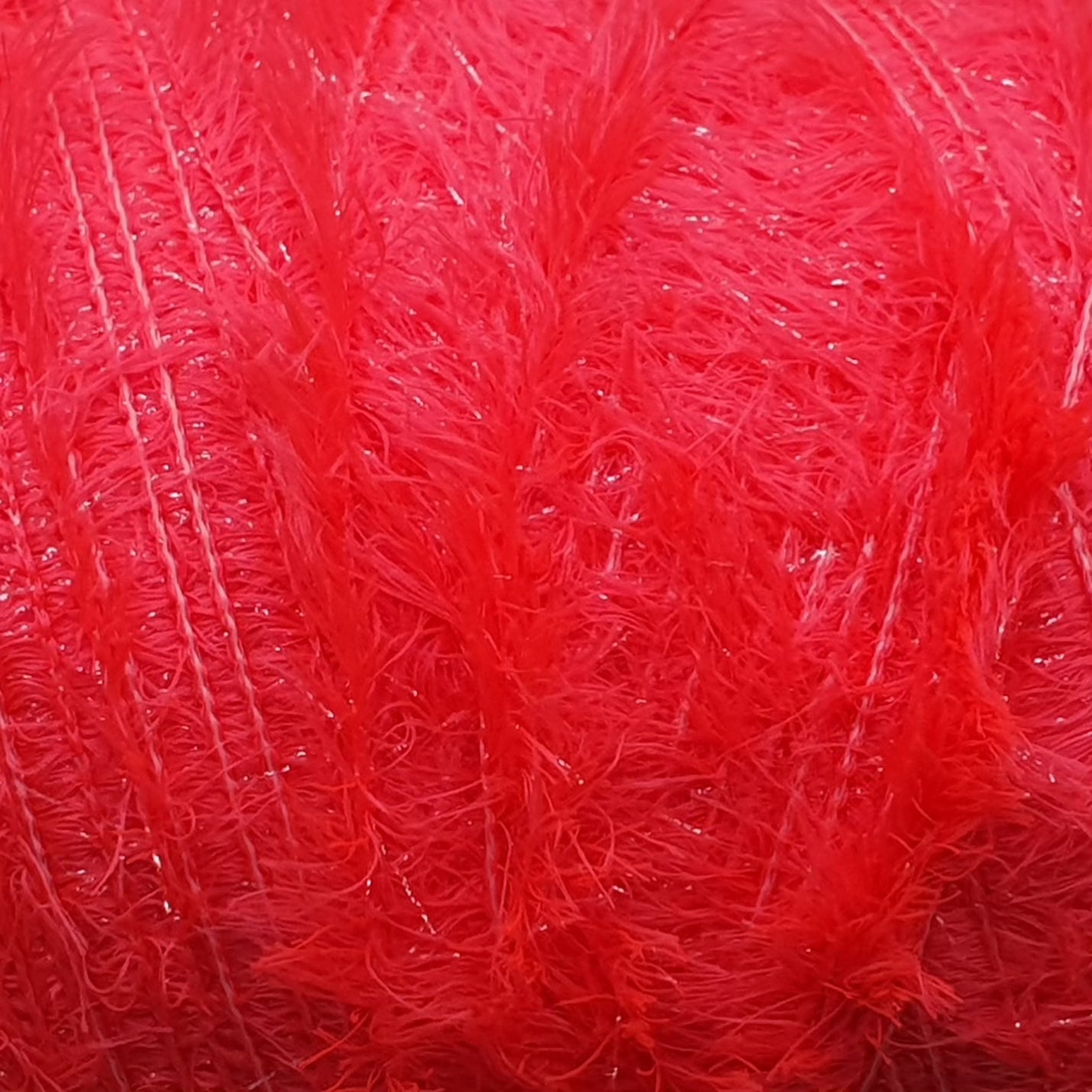 Close-up of Upavon Pure Colour Straggle Hackle fly tying material, showcasing vibrant feather fibers for fishing lures.