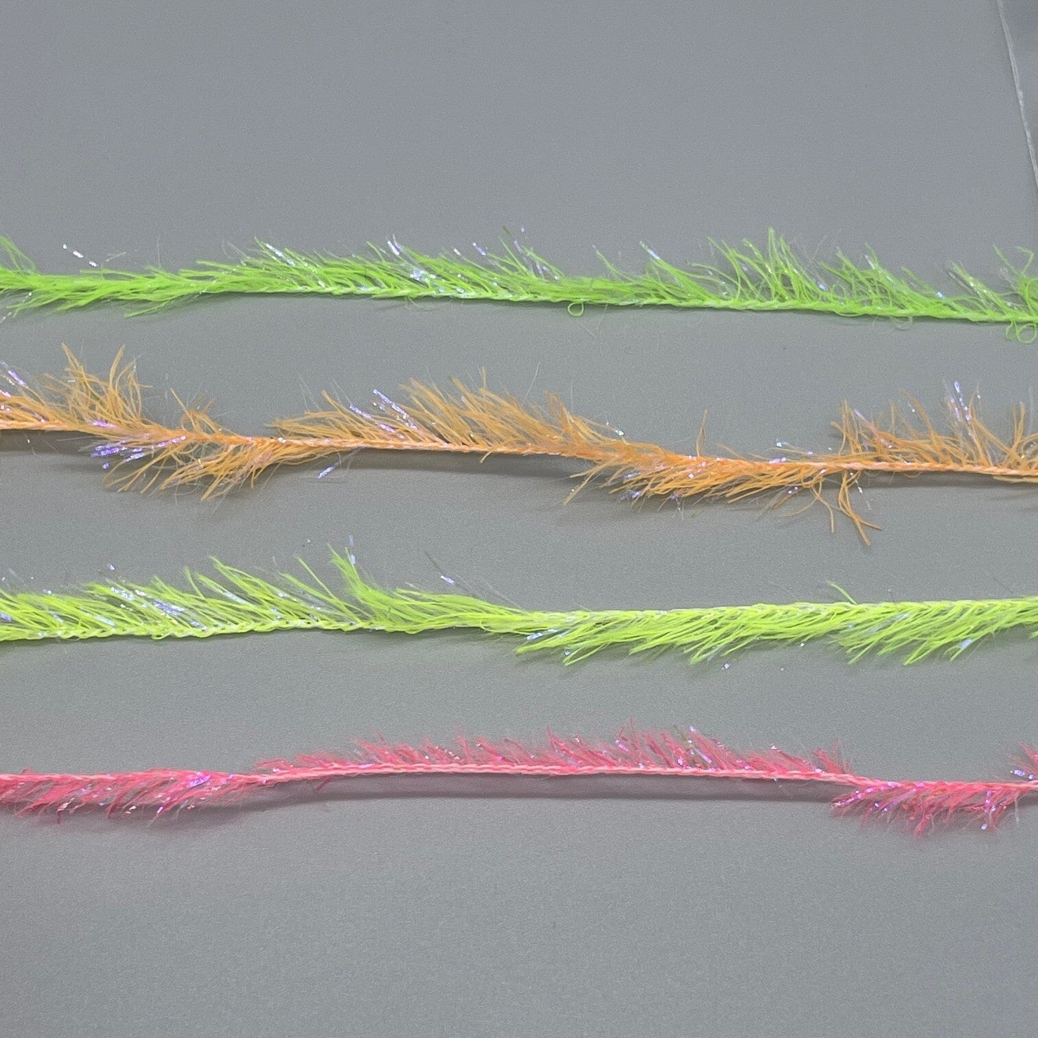 Upavon UV Boosted Straggle Hackle in UV orange, fly tying materials by UPAVON FLY FISHING, showing 4mm UV hackle fibers